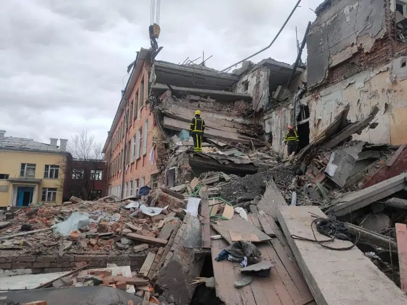 Rescue workers examining the rubble of School No. 18 in Chernihiv