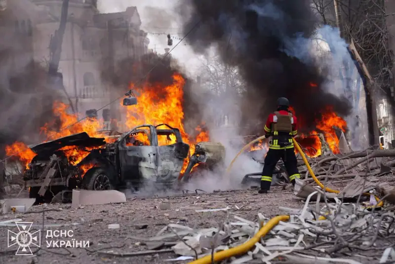 A firefighter tackles burning cars in central Sumy after the missile strike